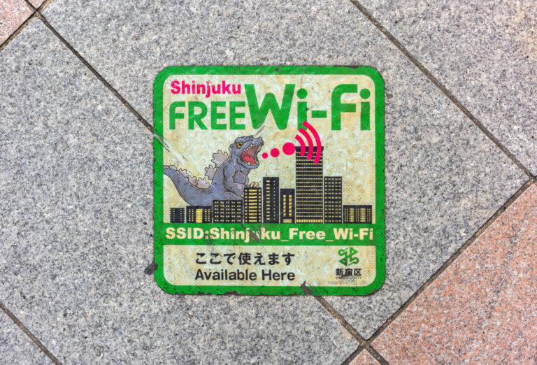 tokyo, japan - aug 7 2023: Sidewalk sticker of an illustration of the radioactive monster Godzilla emitting radio waves for an ad of the public wireless LAN free wi-fi services provided by Shinjuku.
