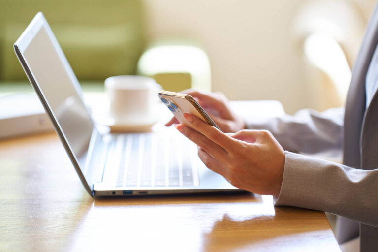 Hand of an Asian woman operating a computer at a cafe