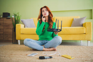 Full body portrait of nice young girl hold router think weekend modern green interior flat indoors.