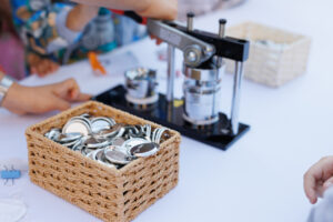 Mechanical manual press. Children and adults make badges