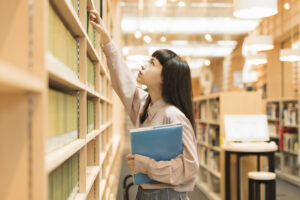 Female university student studying at the library