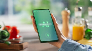 Hand Holds a Smartphone Displaying an AI Chatbot Interface. Device Shows Recipe Ingredients and Instructions, Ai Assistant Provides Culinary Guidance. Technology Helps Mobile Phone User